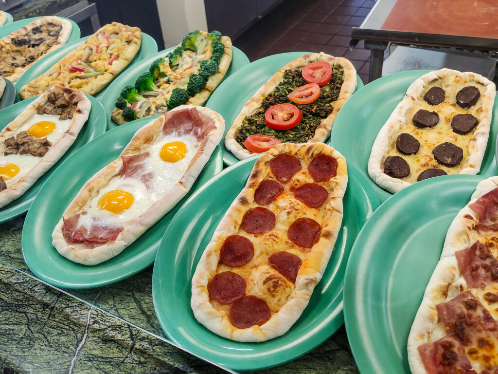 Delicious turkish pide with cheese, eggs or vegetables, at the farmers market in Los Angeles