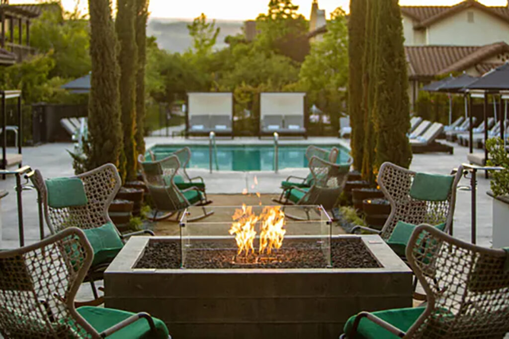 Resort fire pit with view of the pool