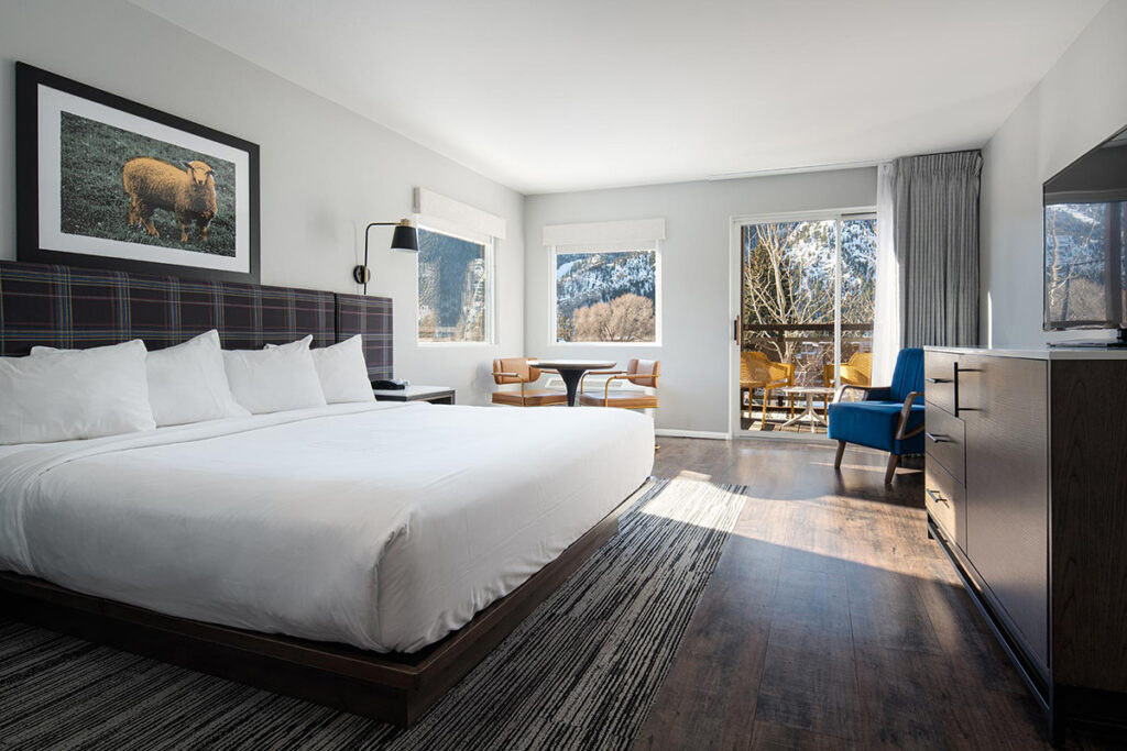Hotel guest room with king bed and balcony