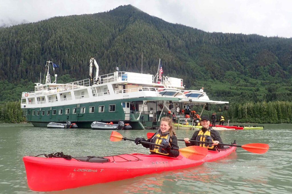 Kayaks launching from the Wilderness Adventurer small cruise ship in Alaska