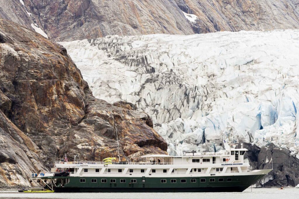The Wilderness Discoverer small cruise ship exploring of one of Alaska's Glaciers