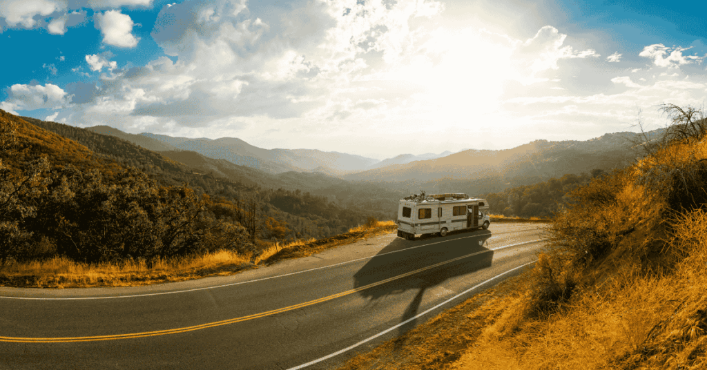 RV parked at the roadside as people step out to admire sweeping views of American scenery with mountains and open plains