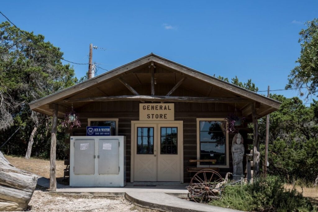 Exterior of the general store at Mayan Dude Ranch in Bandera, Texas, featuring rustic cowboy-style architecture and guest amenities.
