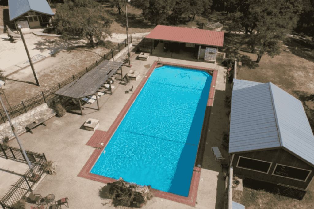 Outdoor swimming pool at Mayan Dude Ranch in Bandera, Texas, surrounded by Hill Country views and rustic ranch-style charm.