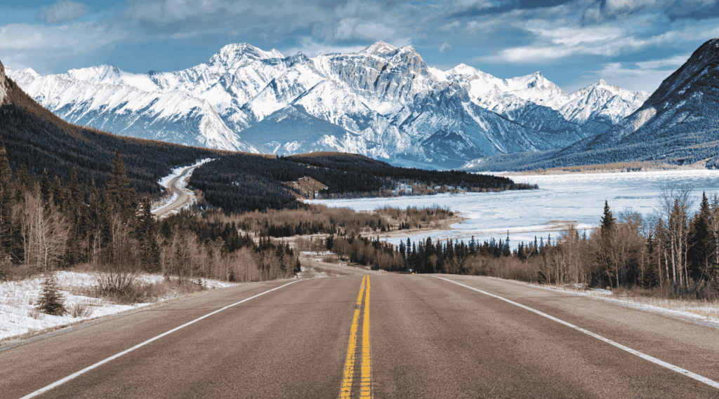 Beautiful scenery of Road trip on highway with rocky mountains and frozen lake at Icefields Parkway, Alberta, Canada