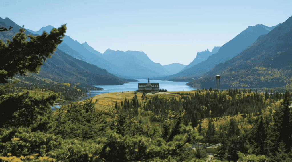 Scenic view of the Prince of Wales Hotel surrounded by forest and mountains in Waterton Lakes National Park