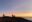 Person enjoying sunrise at Haleakalā, Hawaii, USA