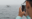 A young man takes a photo of a humpback whale tail with his mobile phone on a whale watching boat in the Atlantic Ocean off the Gloucester coast of Massachusetts.